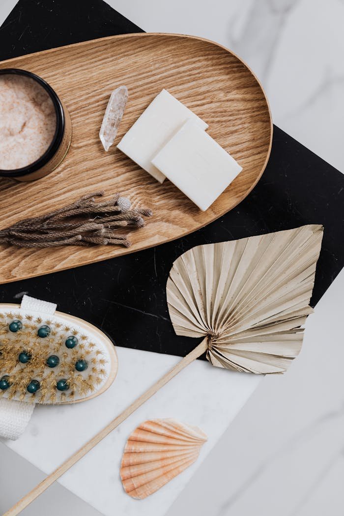 Natural spa products arranged on a wooden tray showcasing eco-friendly self-care items.